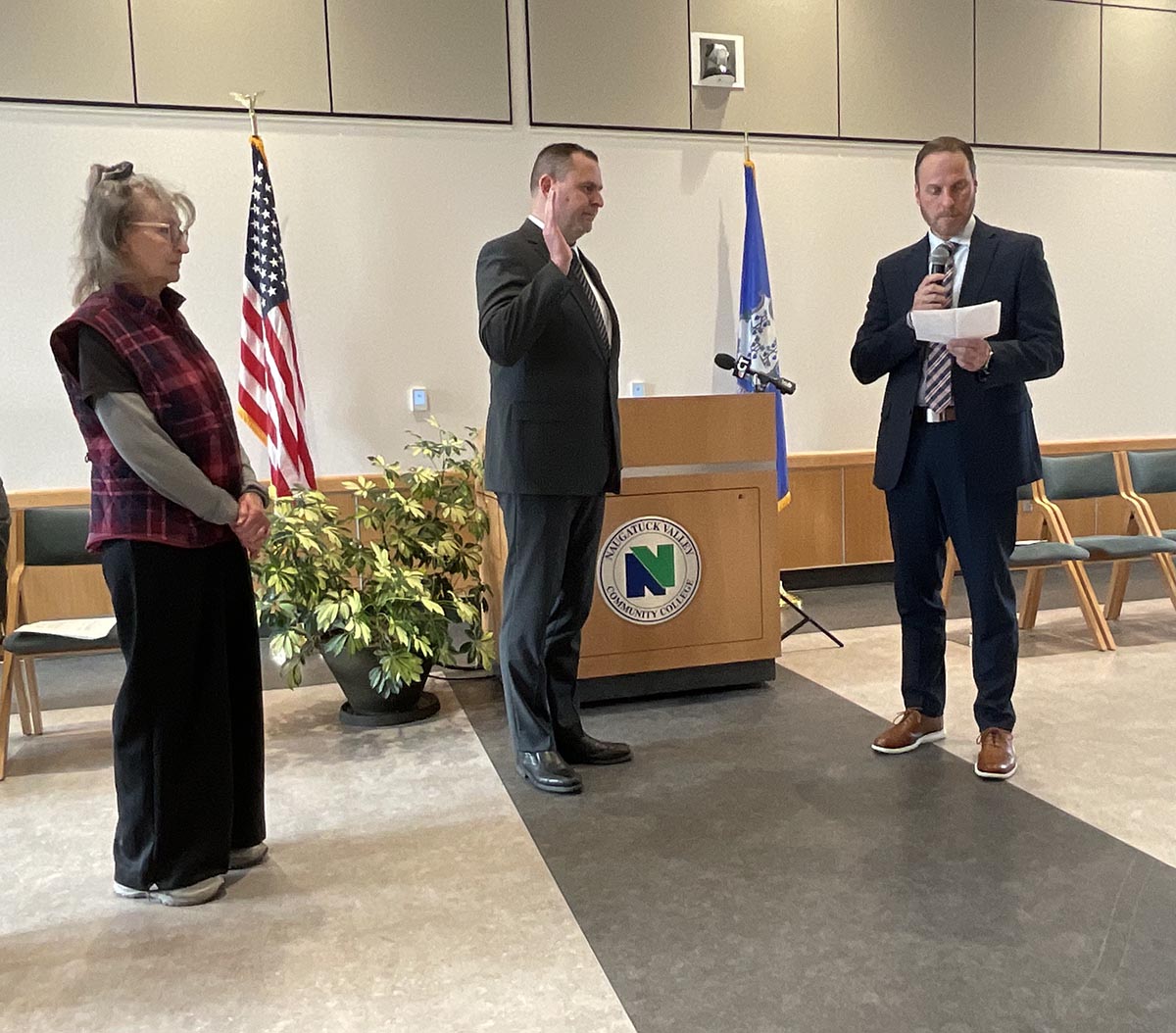 T State Community College's first chief of police Chris Chute (center) is sworn in by Chris Watson, state's attorney as his mother Norma Chute (left) looks on