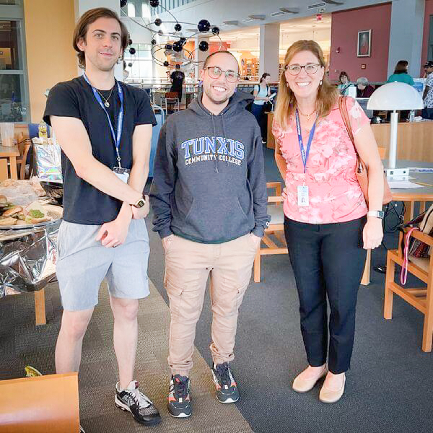 three students standing together and smiling